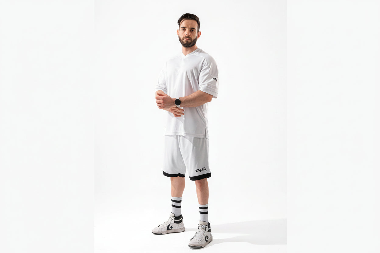 Man wearing a white outfit with black accents on a white background