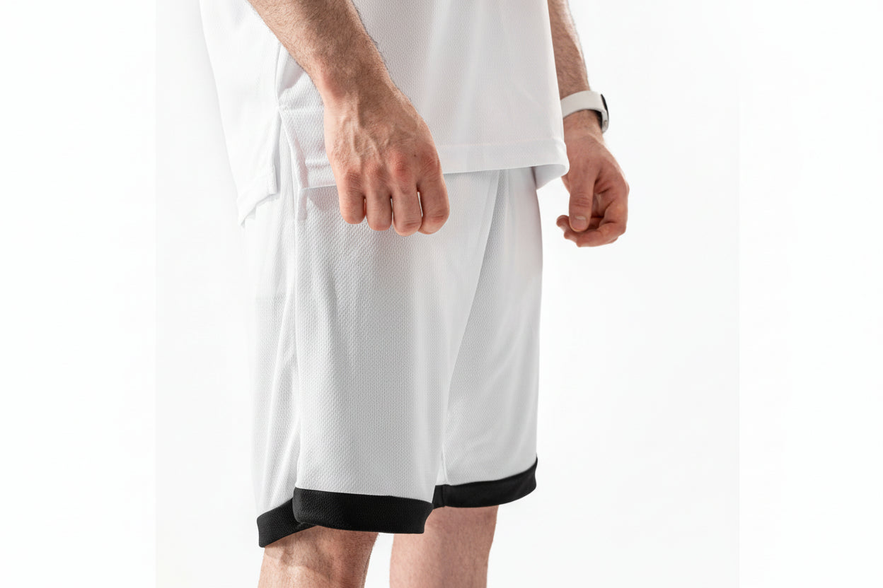 White shorts with black trim worn by a person on a white background