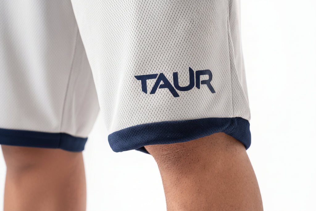 Close-up of a white sports jersey with 'TAUR' logo on a white background