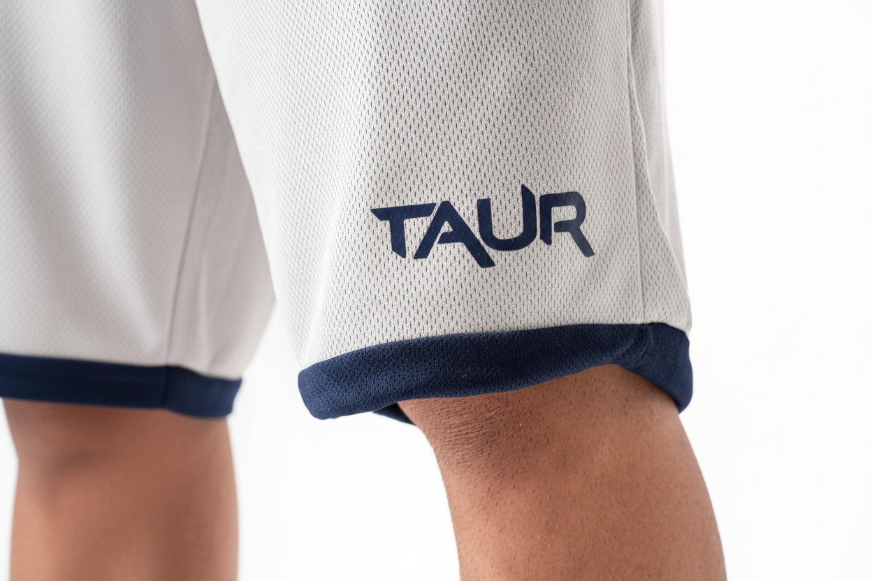 Close-up of a white sports jersey with 'TAUR' logo on a white background