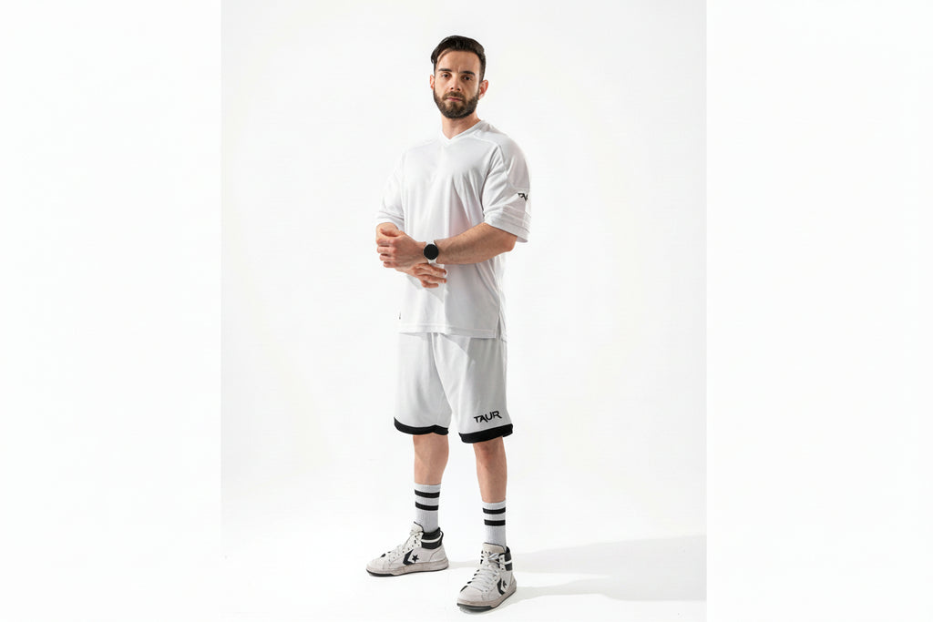 Man wearing a white outfit with black accents on a white background