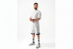 Man wearing a white outfit with black accents on a white background