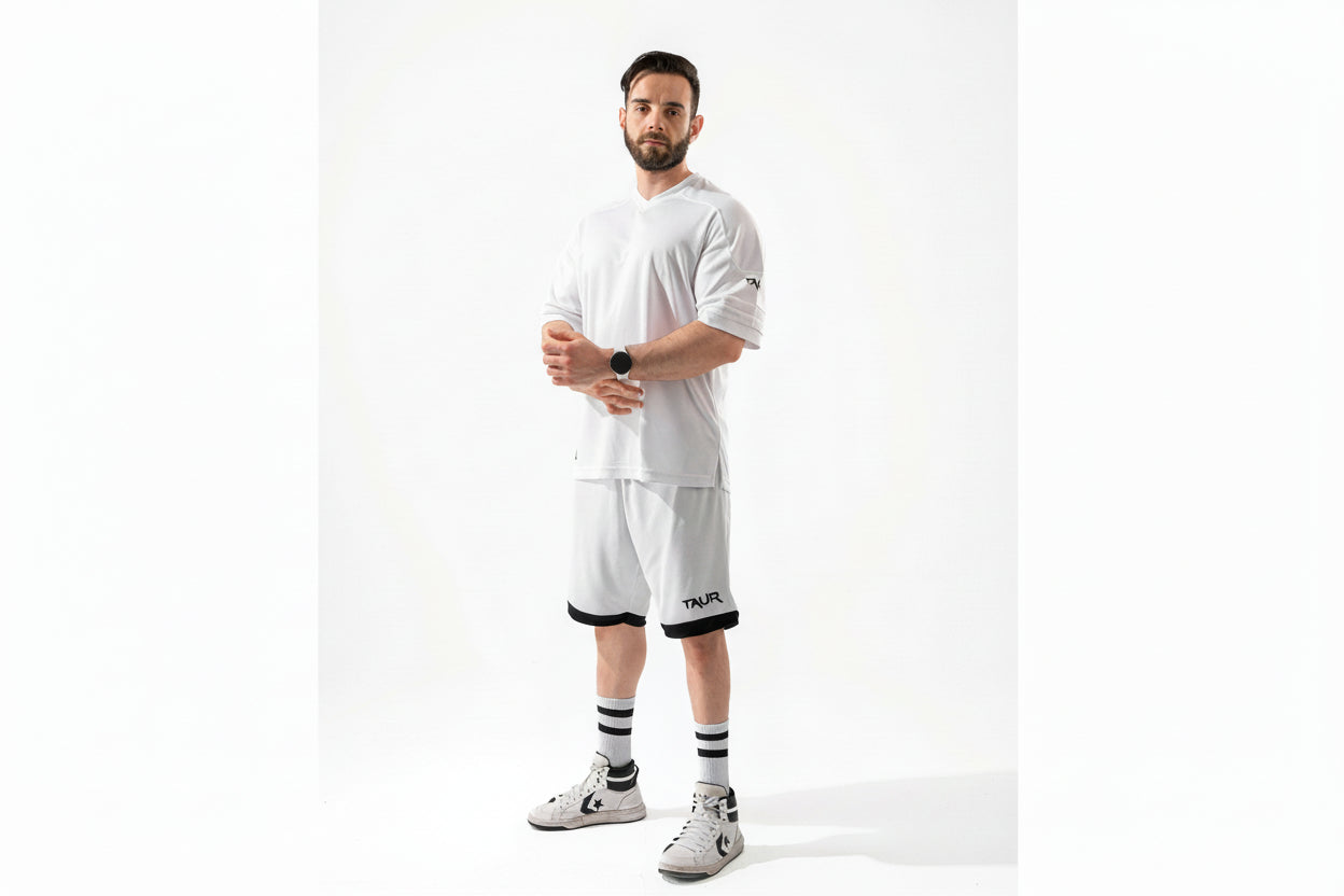 Man wearing a white outfit with black accents on a white background