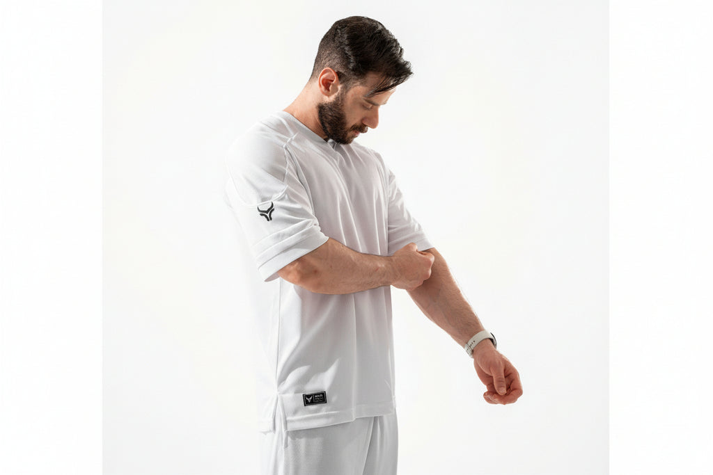 Man wearing a white long-sleeve shirt with a logo on a white background

