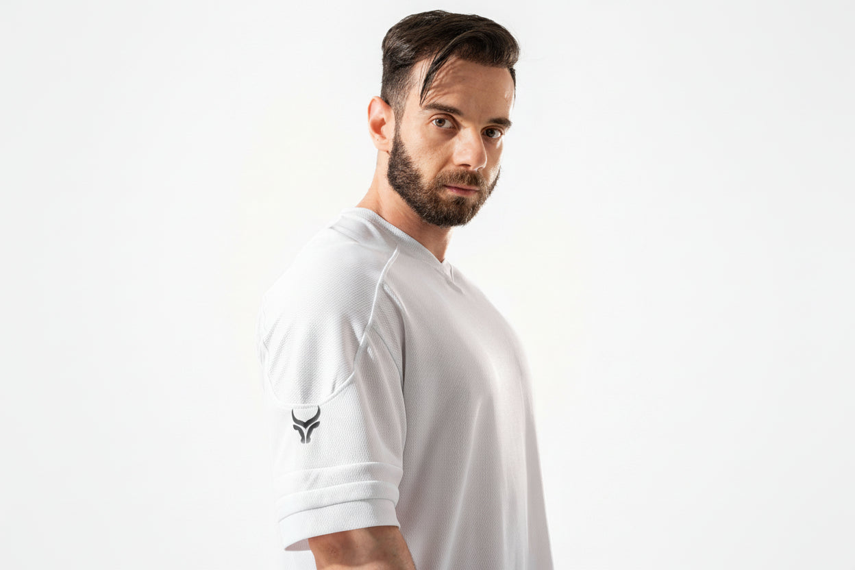 Man wearing a white t-shirt with a logo on a white background

