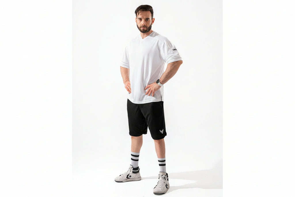 Man wearing a white t-shirt and black shorts on a white background