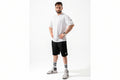 Man wearing a white t-shirt and black shorts on a white background