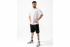 Man wearing a white t-shirt and black shorts on a white background