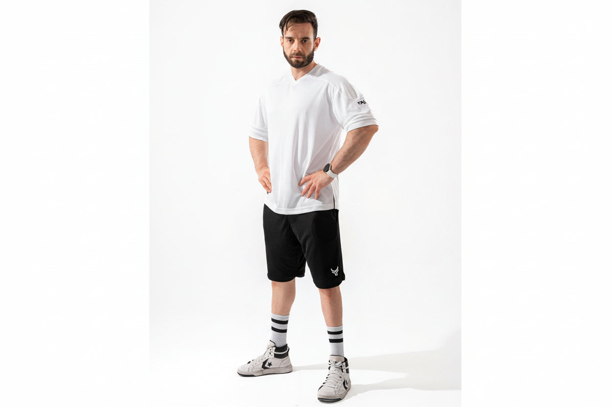 Man wearing a white t-shirt and black shorts on a white background