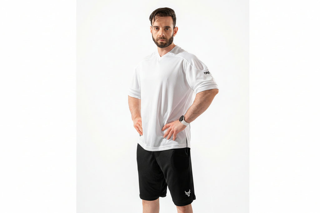 Man wearing a white t-shirt and black shorts on a white background