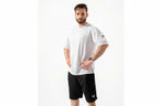 Man wearing a white t-shirt and black shorts on a white background