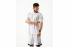 Man wearing a white t-shirt and shorts with 'Taur' branding on a white background

