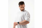 Man wearing a white t-shirt with a brand logo on a white background