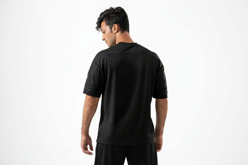 Man wearing a black athletic shirt on a white background

