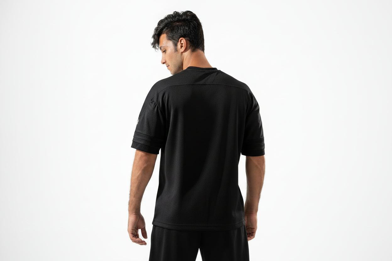 Man wearing a black athletic shirt on a white background

